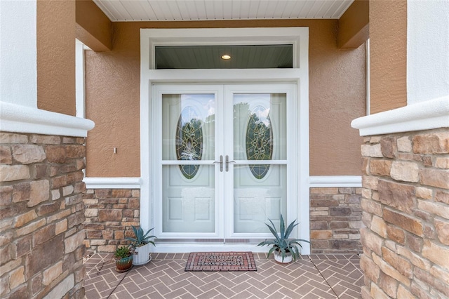 12804 SE 90th Court Rd, Summerfield, FL 34491 - property entrance with french doors, stucco siding, and stone siding