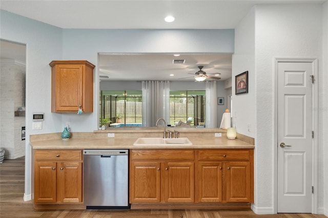 12804 SE 90th Court Rd, Summerfield, FL 34491 - kitchen featuring stainless steel dishwasher, a sink, a ceiling fan, wood finished floors, and light countertops