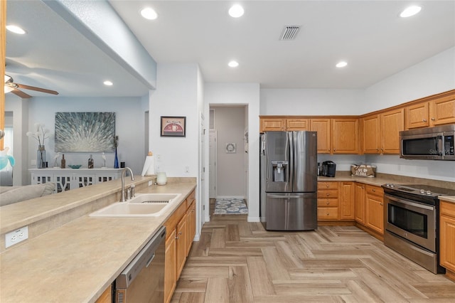 12804 SE 90th Court Rd, Summerfield, FL 34491 - kitchen with stainless steel appliances, a sink, ceiling fan, light countertops, and recessed lighting