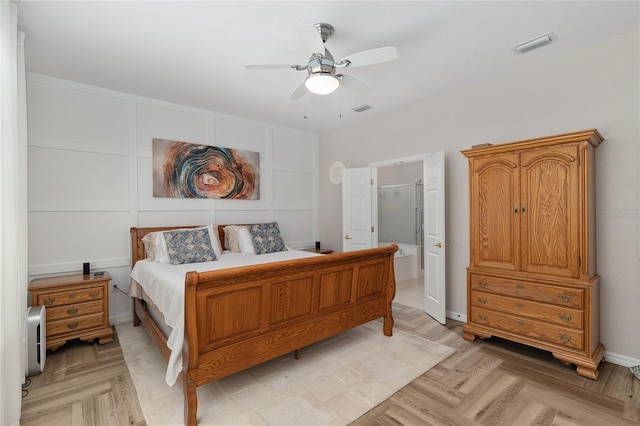 12804 SE 90th Court Rd, Summerfield, FL 34491 - bedroom featuring a ceiling fan, ensuite bath, and a decorative wall