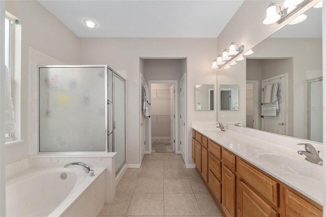 12804 SE 90th Court Rd, Summerfield, FL 34491 - full bathroom featuring a stall shower, a bath, double vanity, tile patterned flooring, and a walk in closet