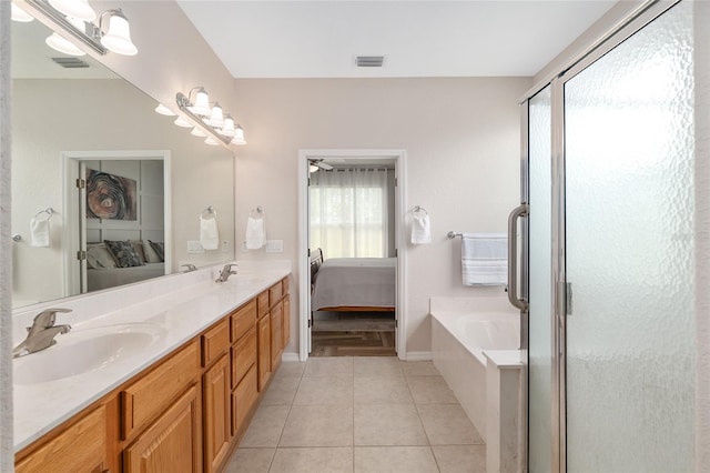 12804 SE 90th Court Rd, Summerfield, FL 34491 - ensuite bathroom featuring a bath, double vanity, tile patterned flooring, and a stall shower