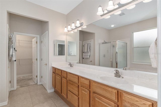 12804 SE 90th Court Rd, Summerfield, FL 34491 - full bathroom with a stall shower, double vanity, a spacious closet, tile patterned flooring, and baseboards