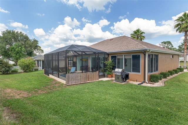 12804 SE 90th Court Rd, Summerfield, FL 34491 - rear view of house with a lawn, a lanai, a patio, and roof with shingles