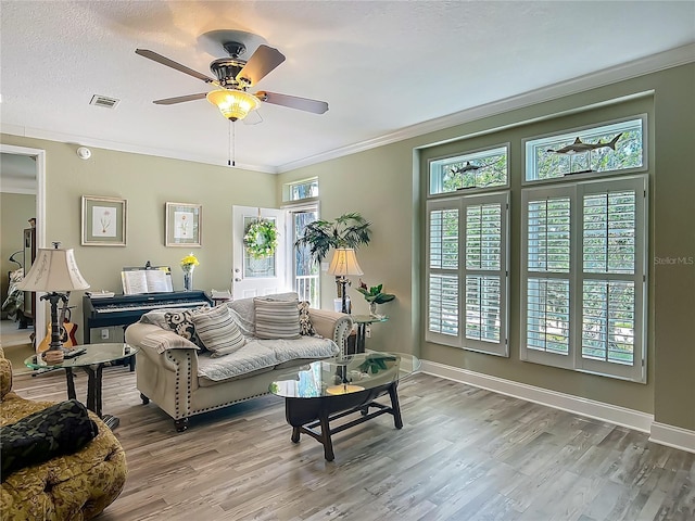 1575 S Wallace Pt Unit 23, Crystal River, FL 34429 - living area featuring wood finished floors, a ceiling fan, crown molding, and baseboards