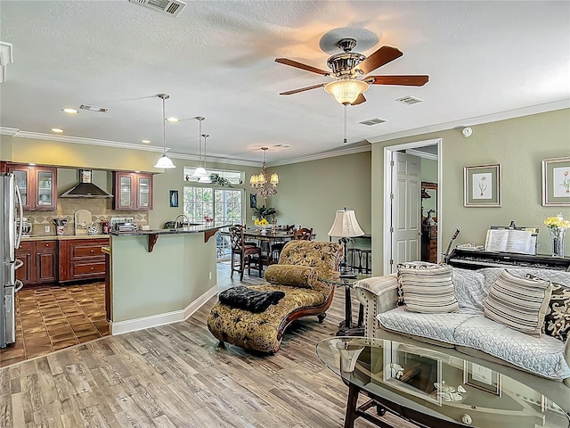 1575 S Wallace Pt Unit 23, Crystal River, FL 34429 - living room with a ceiling fan, crown molding, a chandelier, wood finished floors, and recessed lighting
