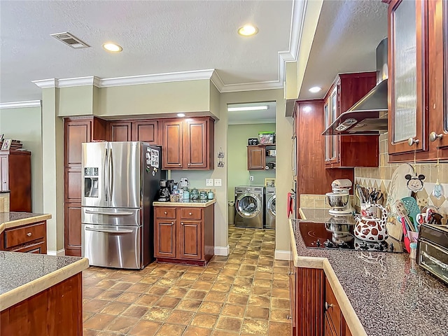 1575 S Wallace Pt Unit 23, Crystal River, FL 34429 - kitchen with stainless steel fridge, washer and dryer, crown molding, wall chimney exhaust hood, and black electric cooktop