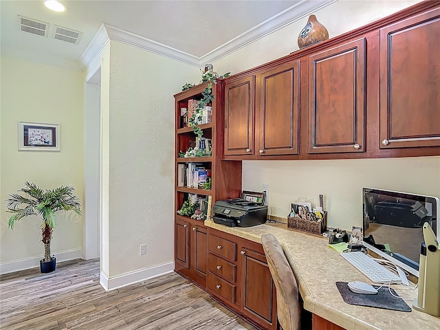 1575 S Wallace Pt Unit 23, Crystal River, FL 34429 - home office featuring built in desk, light wood-type flooring, baseboards, and ornamental molding