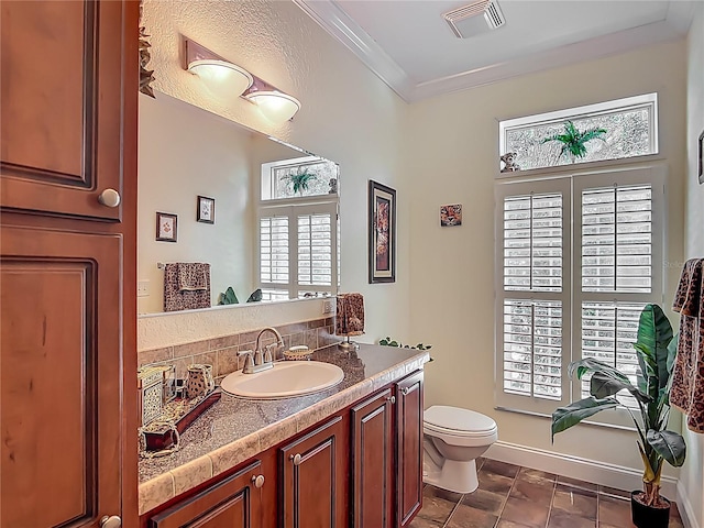1575 S Wallace Pt Unit 23, Crystal River, FL 34429 - bathroom with toilet, vanity, plenty of natural light, baseboards, and ornamental molding