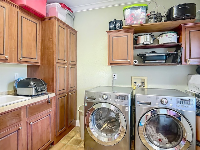 1575 S Wallace Pt Unit 23, Crystal River, FL 34429 - laundry area with washing machine and dryer, cabinet space, crown molding, and light tile patterned floors