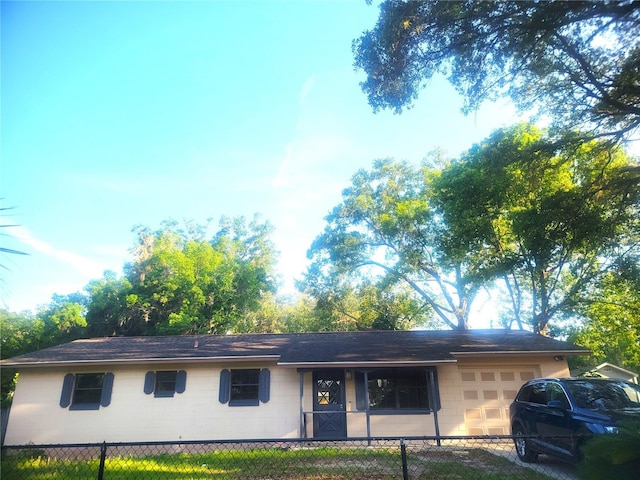 3740 NE 5th St, Ocala, FL 34470 - ranch-style home featuring a garage, concrete block siding, and roof with shingles
