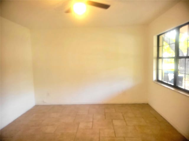 3740 NE 5th St, Ocala, FL 34470 - empty room featuring a ceiling fan and stone finish flooring