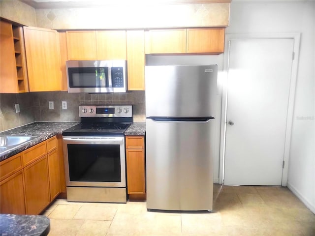 3740 NE 5th St, Ocala, FL 34470 - kitchen featuring stainless steel appliances, open shelves, tasteful backsplash, brown cabinetry, and a sink