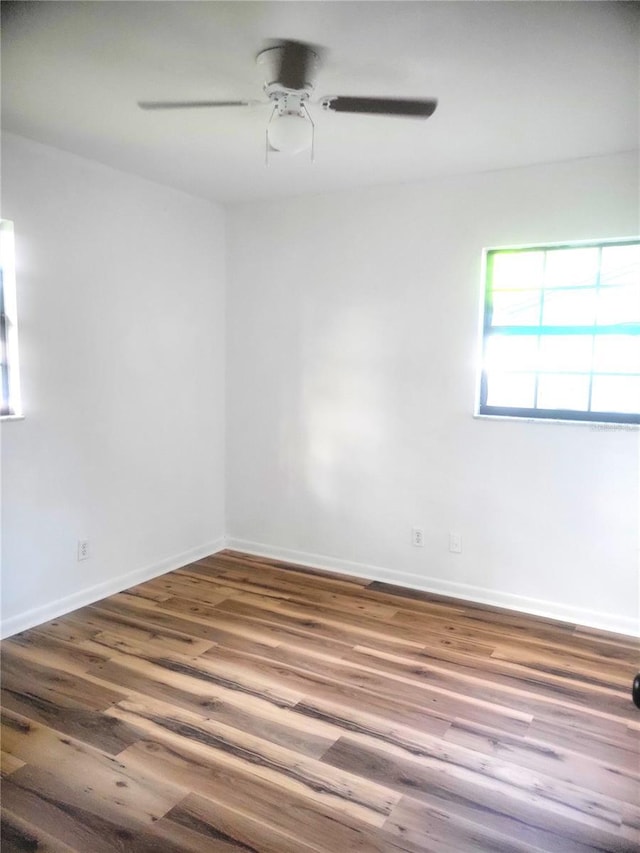 3740 NE 5th St, Ocala, FL 34470 - empty room featuring wood finished floors, a ceiling fan, and baseboards
