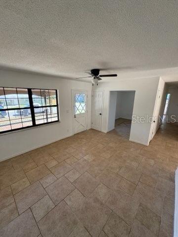 3740 NE 5th St, Ocala, FL 34470 - unfurnished room featuring a textured ceiling and ceiling fan