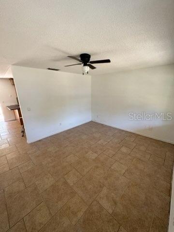 3740 NE 5th St, Ocala, FL 34470 - empty room with a ceiling fan and a textured ceiling