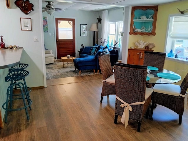 22736 SW 117th St, Dunnellon, FL 34431 - dining space featuring wood finished floors, plenty of natural light, ceiling fan, and stairway