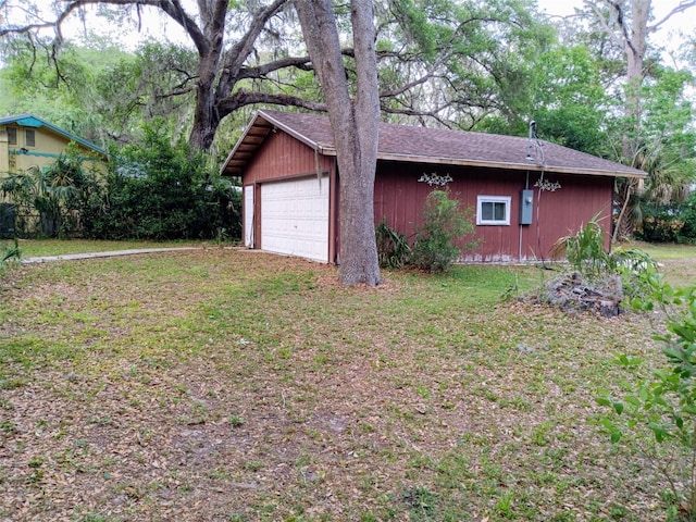 22736 SW 117th St, Dunnellon, FL 34431 - view of side of property with a garage, a shingled roof, and a lawn