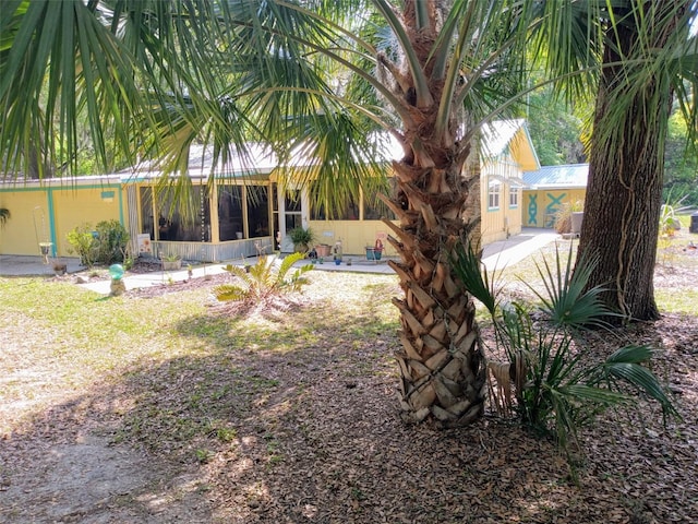 22736 SW 117th St, Dunnellon, FL 34431 - back of property with a sunroom and a patio area