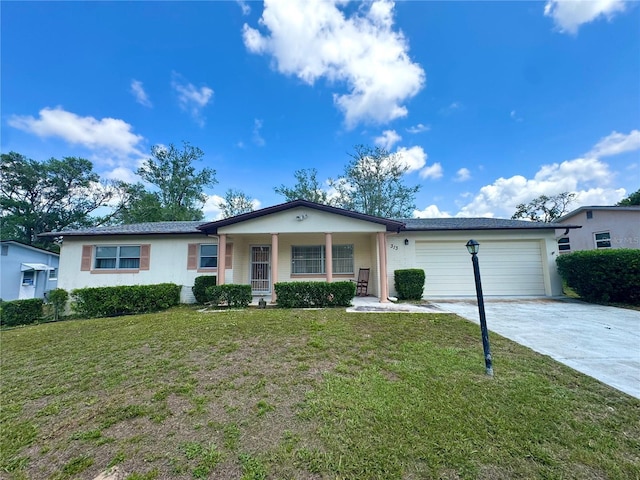 313 S Adams St, Beverly Hills, FL 34465 - ranch-style house with an attached garage, driveway, a front yard, covered porch, and stucco siding