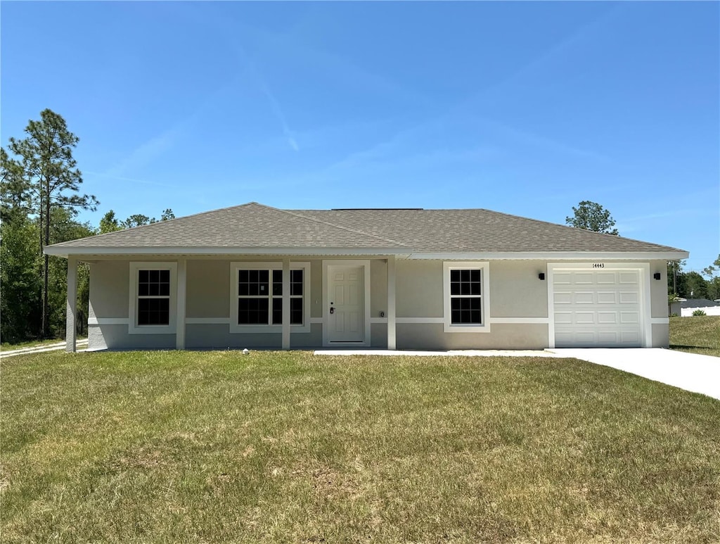 14443 SW 21st Pl, Ocala, FL 34481 - ranch-style house featuring stucco siding, a front lawn, an attached garage, and driveway