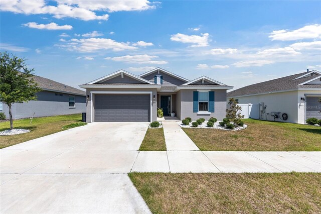 7571 SW 64th Street Rd, Ocala, FL 34474 - single story home with an attached garage, driveway, a front yard, and stucco siding
