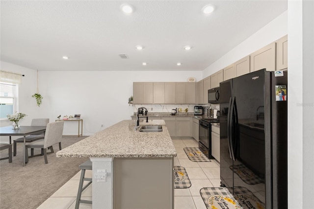 7571 SW 64th Street Rd, Ocala, FL 34474 - kitchen featuring black appliances, a sink, an island with sink, a kitchen bar, and recessed lighting