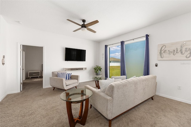 7571 SW 64th Street Rd, Ocala, FL 34474 - living room featuring light carpet, a ceiling fan, and baseboards
