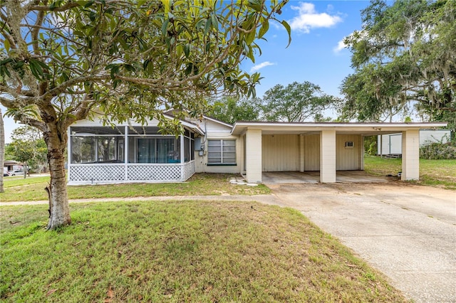 705 Washington Ave, Eustis, FL 32726 - view of front of property featuring a front lawn, a carport, concrete driveway, and a sunroom