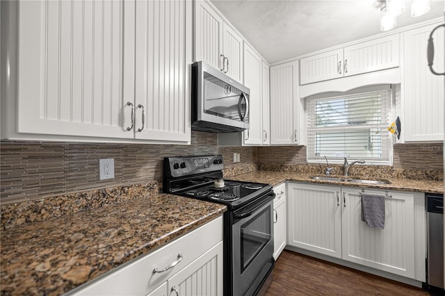 705 Washington Ave, Eustis, FL 32726 - kitchen with appliances with stainless steel finishes, a sink, decorative backsplash, and white cabinets