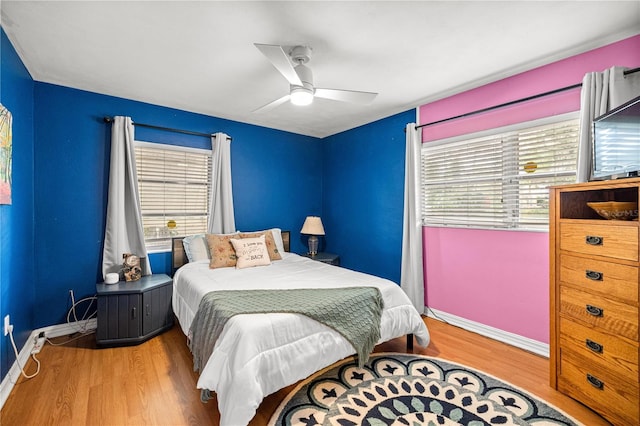 705 Washington Ave, Eustis, FL 32726 - bedroom with multiple windows, baseboards, wood finished floors, and ceiling fan