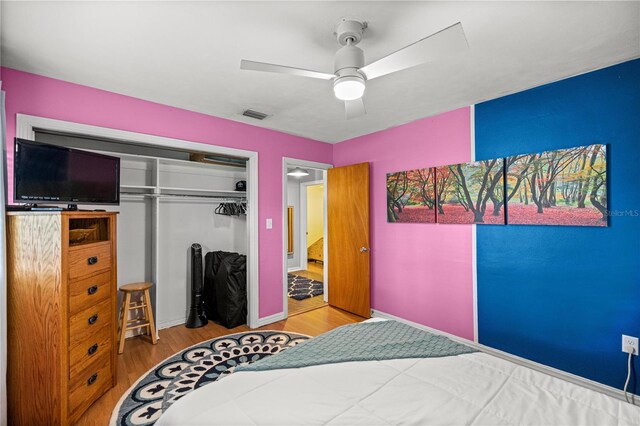 705 Washington Ave, Eustis, FL 32726 - bedroom featuring wood finished floors, a closet, ceiling fan, and baseboards