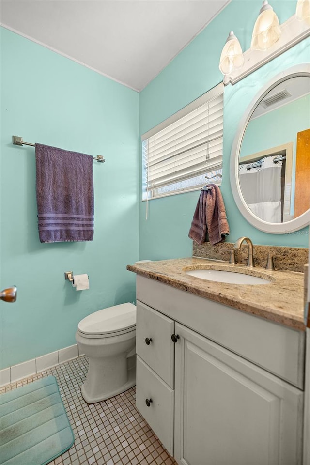 705 Washington Ave, Eustis, FL 32726 - bathroom featuring vanity, toilet, and tile patterned floors