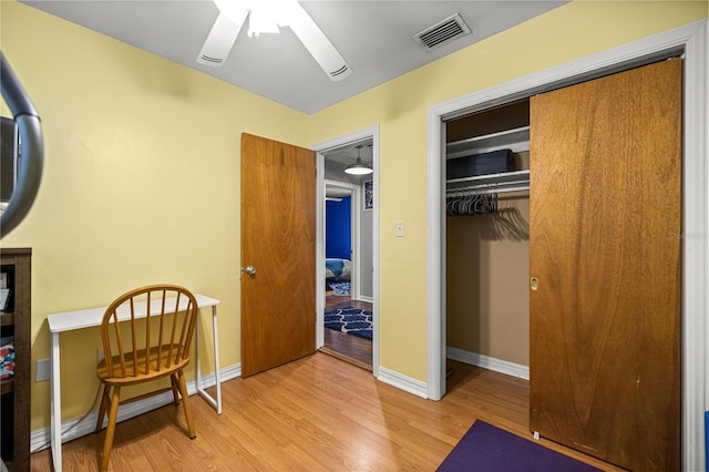 705 Washington Ave, Eustis, FL 32726 - bedroom with light wood-style floors, a closet, baseboards, and a ceiling fan