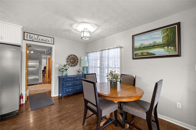 705 Washington Ave, Eustis, FL 32726 - dining room featuring dark wood-type flooring and baseboards