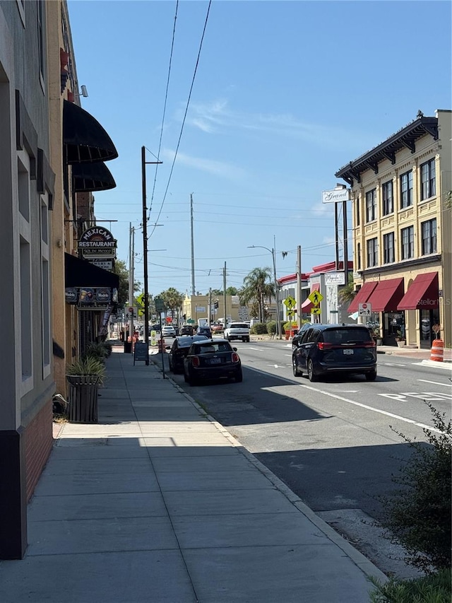 705 Washington Ave, Eustis, FL 32726 - view of asphalt road with sidewalks, street lights, and curbs