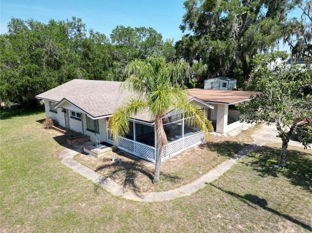 705 Washington Ave, Eustis, FL 32726 - view of front of property featuring dirt driveway, a front lawn, a shingled roof, and a sunroom