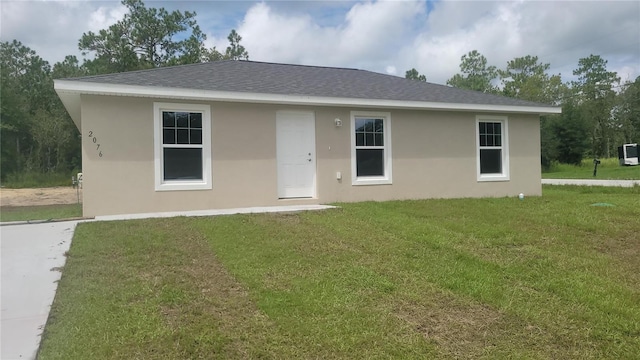 20443 SW Rainbow Lakes Blvd, Dunnellon, FL 34431 - view of front of home with a front yard, stucco siding, and roof with shingles