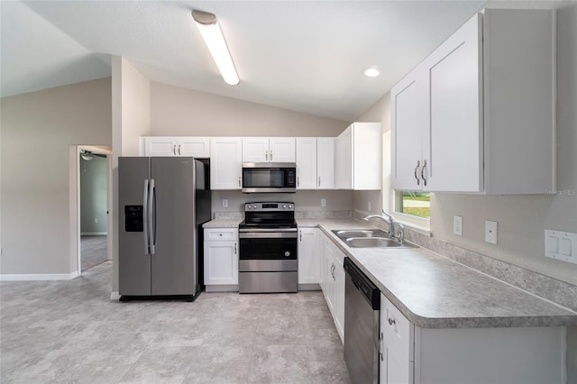 20443 SW Rainbow Lakes Blvd, Dunnellon, FL 34431 - kitchen featuring appliances with stainless steel finishes, a sink, lofted ceiling, white cabinets, and light countertops