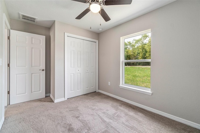 20443 SW Rainbow Lakes Blvd, Dunnellon, FL 34431 - unfurnished bedroom featuring carpet floors, baseboards, a closet, and ceiling fan