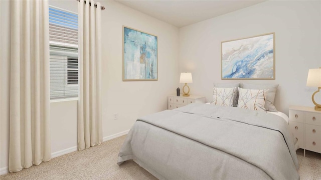 12791 NW 13th Ln, Newberry, FL 32669 - bedroom featuring light colored carpet, baseboards, and multiple windows