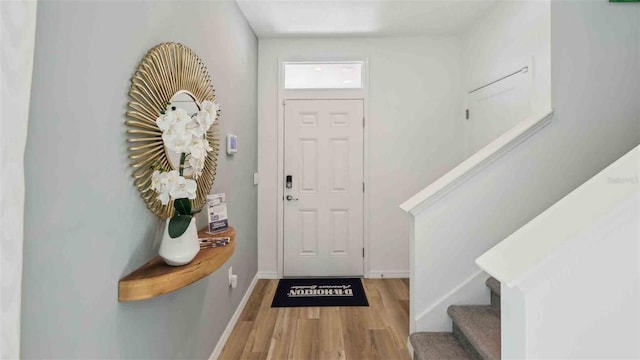 4937 SW 51st Rd, Gainesville, FL 32608 - foyer entrance featuring stairway, wood finished floors, and baseboards