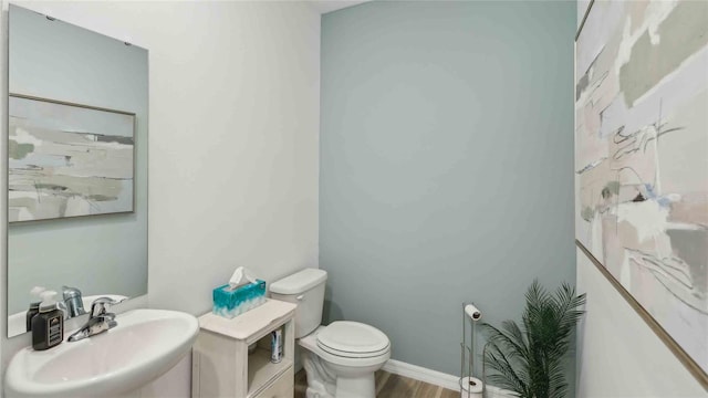 4937 SW 51st Rd, Gainesville, FL 32608 - half bath with toilet, a sink, and wood finished floors
