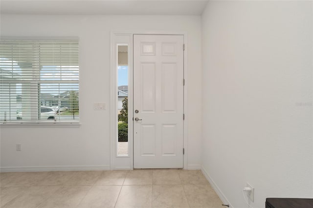 7224 SW 61st Pl, Ocala, FL 34474 - foyer with light tile patterned floors and baseboards