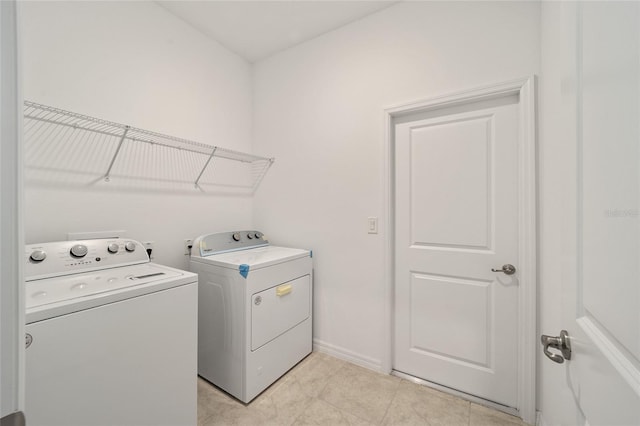 7224 SW 61st Pl, Ocala, FL 34474 - washroom with independent washer and dryer, light tile patterned flooring, and baseboards