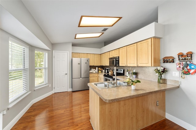 11 SE Fir Trail Trak, Ocala, FL 34472 - kitchen featuring stainless steel appliances, light brown cabinetry, lofted ceiling, tasteful backsplash, and a peninsula