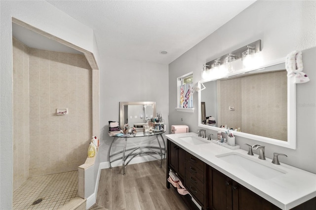 11 SE Fir Trail Trak, Ocala, FL 34472 - bathroom with double vanity, tiled shower, and wood finished floors