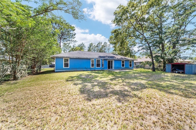 11 SE Fir Trail Trak, Ocala, FL 34472 - back of property with a lawn and an outbuilding