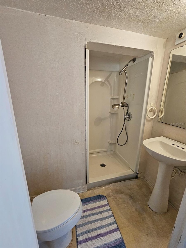 18 Fir Trail Dr, Ocala, FL 34472 - bathroom featuring a stall shower, a textured ceiling, toilet, a textured wall, and baseboards