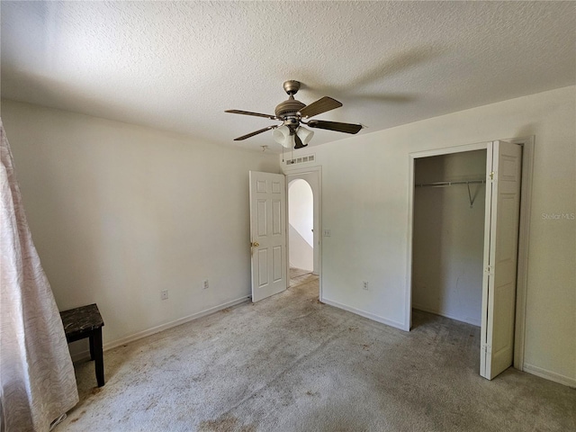18 Fir Trail Dr, Ocala, FL 34472 - unfurnished bedroom with light colored carpet, a ceiling fan, a textured ceiling, a closet, and baseboards